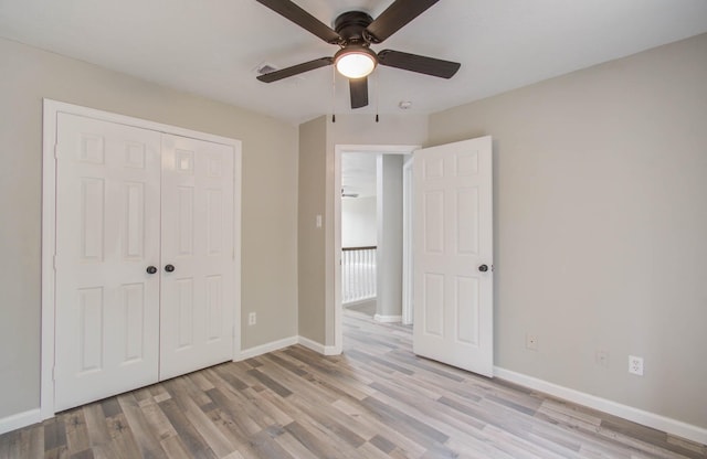 unfurnished bedroom with a closet, visible vents, light wood-style floors, a ceiling fan, and baseboards