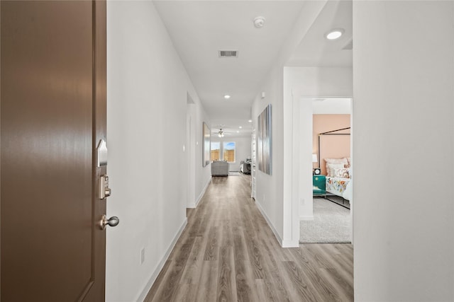 hall with light hardwood / wood-style flooring