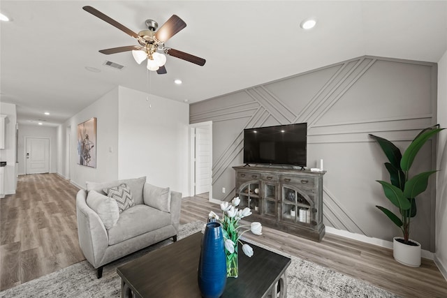 living room with hardwood / wood-style flooring and ceiling fan