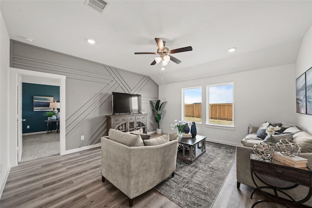 living room with hardwood / wood-style floors, vaulted ceiling, and ceiling fan