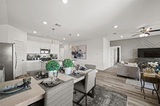 dining space featuring ceiling fan and hardwood / wood-style floors