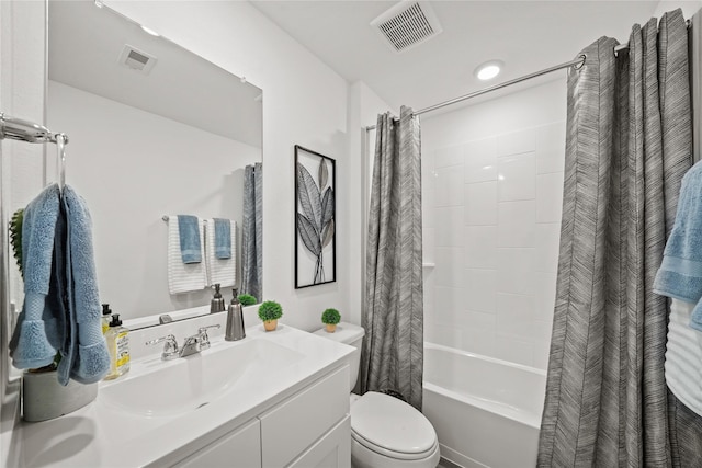 full bathroom with vanity, shower / tub combo, and toilet