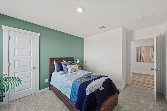 bedroom featuring light colored carpet