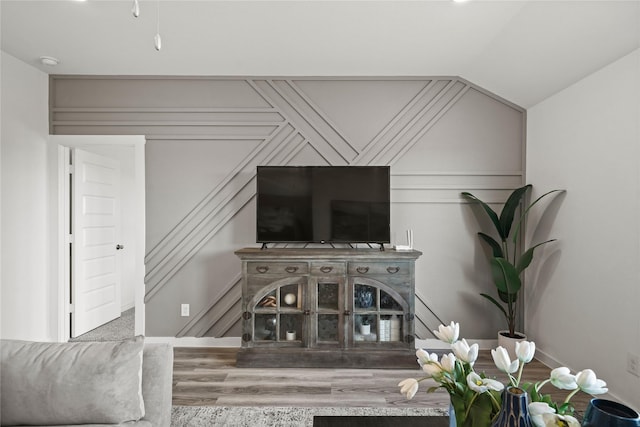 living room featuring wood-type flooring and lofted ceiling