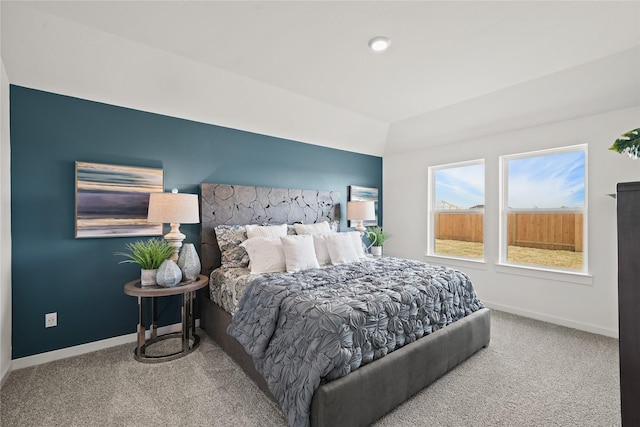 carpeted bedroom with vaulted ceiling