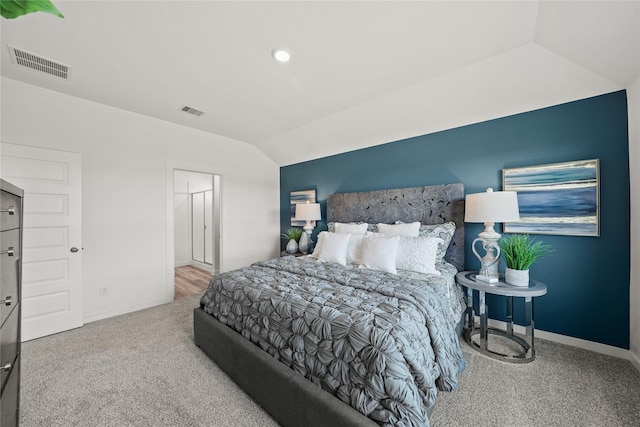 bedroom featuring lofted ceiling and carpet