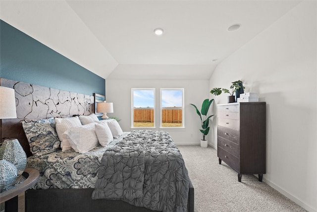 bedroom featuring lofted ceiling and light colored carpet