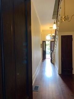 corridor with hardwood / wood-style floors