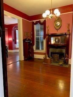 interior space with dark hardwood / wood-style flooring and a notable chandelier