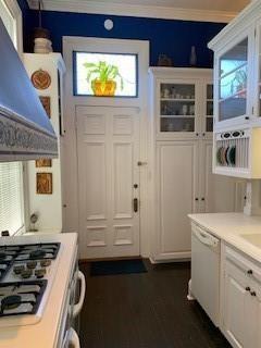 interior space with crown molding and dark wood-type flooring