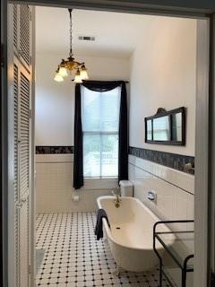 bathroom with tile walls