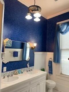 bathroom with crown molding, vanity, tile patterned floors, and toilet