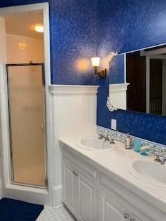 bathroom with vanity, an enclosed shower, and tile patterned floors