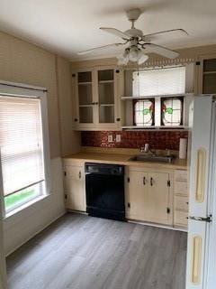 bar featuring black dishwasher, sink, white fridge, ceiling fan, and light hardwood / wood-style flooring