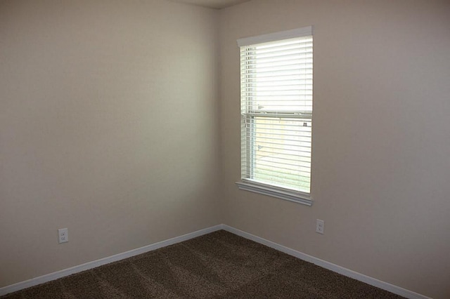 carpeted empty room with baseboards