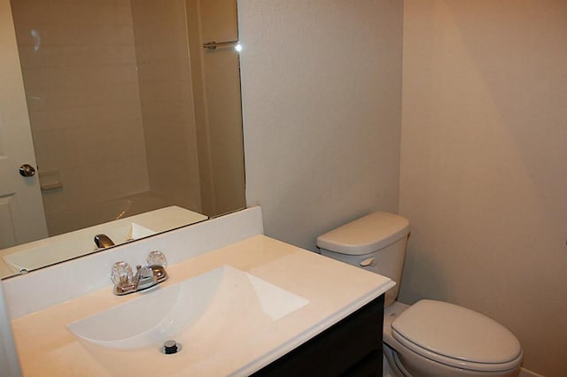 bathroom featuring toilet and vanity