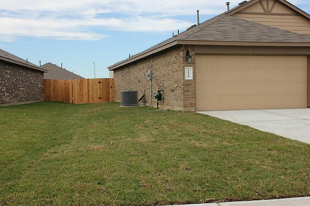 view of side of property with a garage, a lawn, fence, central air condition unit, and brick siding