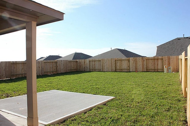 view of yard featuring a patio area and a fenced backyard