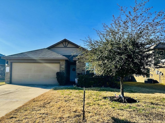 view of front facade featuring a garage, driveway, brick siding, and a front yard