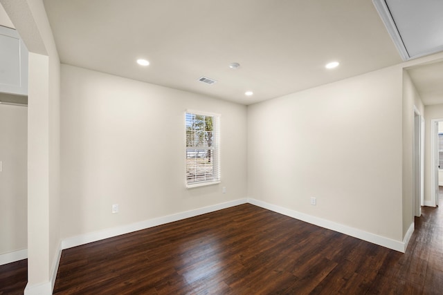 empty room with dark wood-type flooring