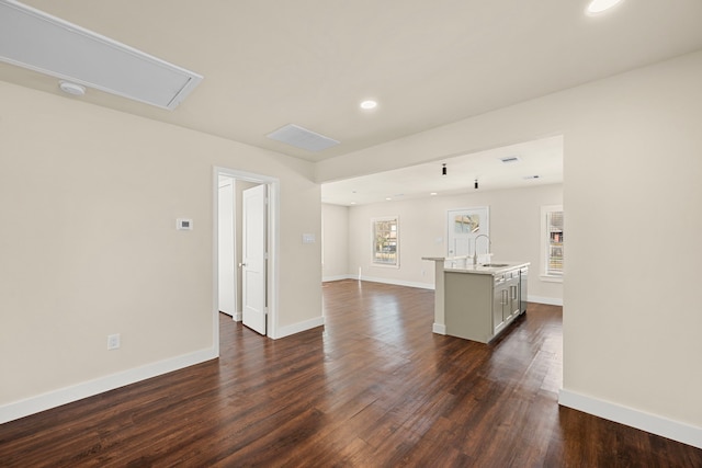 unfurnished living room with sink and dark hardwood / wood-style flooring