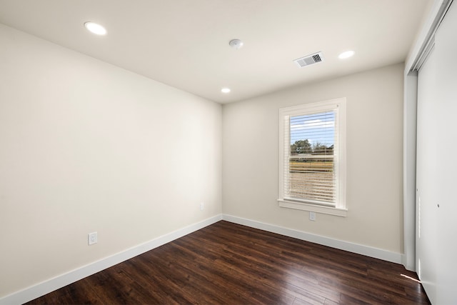 spare room featuring dark wood-type flooring