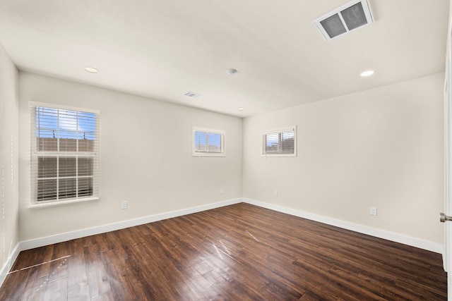 spare room with dark wood-type flooring