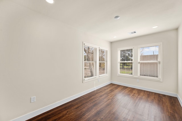 empty room with dark hardwood / wood-style flooring