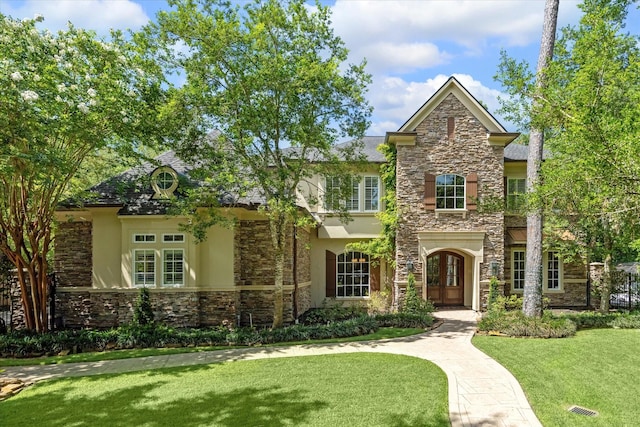 view of front of home with french doors and a front yard