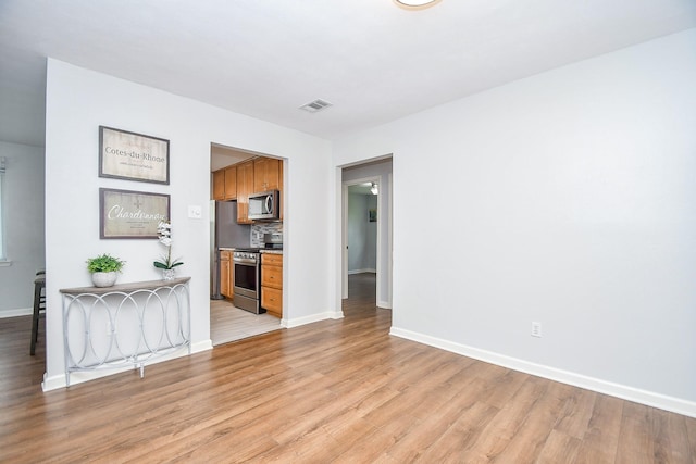 unfurnished living room with light hardwood / wood-style floors