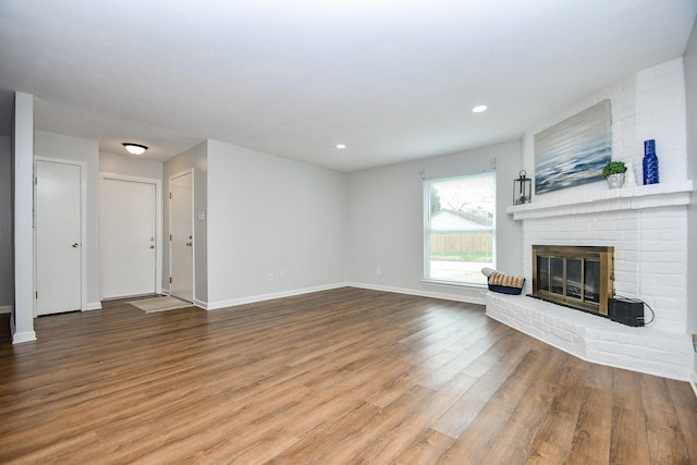 unfurnished living room featuring hardwood / wood-style floors and a fireplace