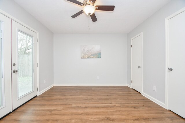 unfurnished room with ceiling fan and light wood-type flooring