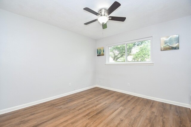 spare room with wood-type flooring and ceiling fan