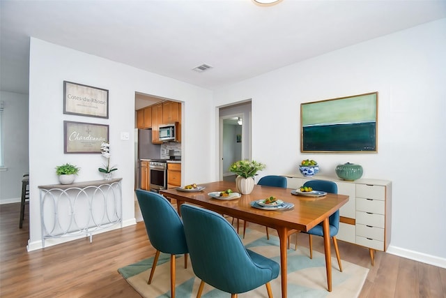 dining room with light wood-type flooring