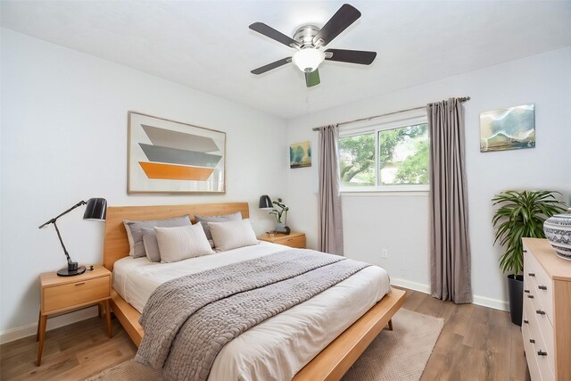 bedroom featuring ceiling fan and light hardwood / wood-style floors