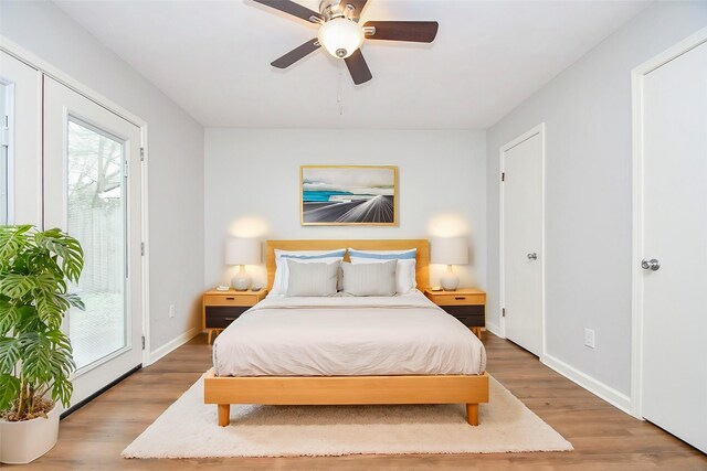 bedroom featuring ceiling fan, hardwood / wood-style floors, and access to outside