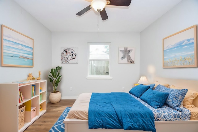 bedroom with hardwood / wood-style flooring and ceiling fan