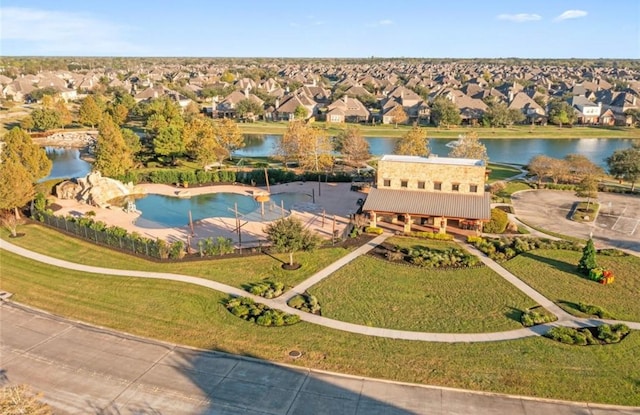 drone / aerial view featuring a residential view and a water view