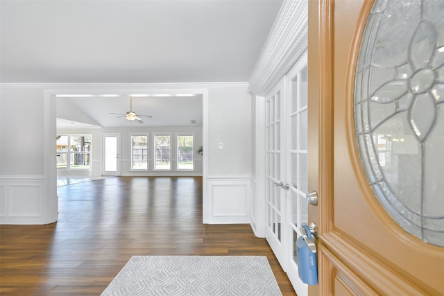 entryway with ornamental molding, dark wood-type flooring, ceiling fan, and french doors