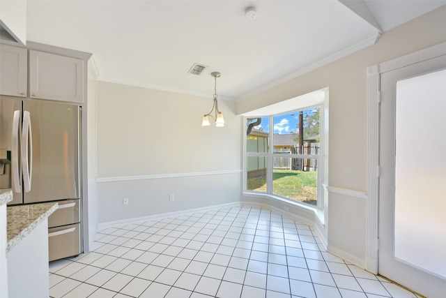 kitchen featuring light tile patterned flooring, stainless steel fridge, hanging light fixtures, crown molding, and an inviting chandelier