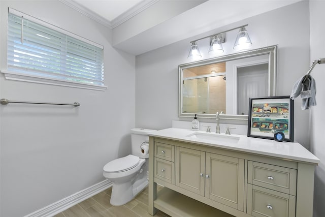 bathroom featuring vanity, an enclosed shower, ornamental molding, and toilet