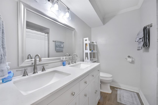 bathroom with vanity, hardwood / wood-style flooring, ornamental molding, and toilet