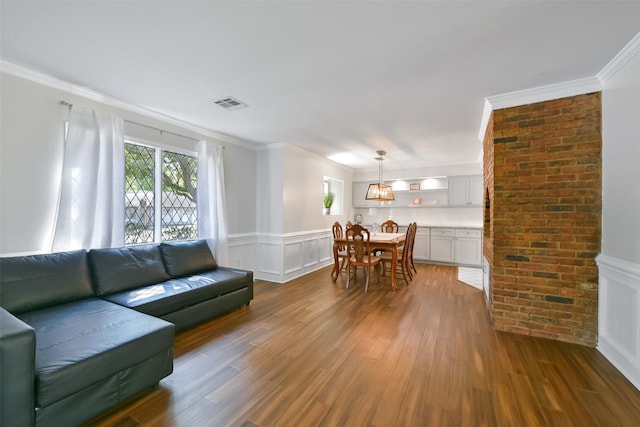 living room featuring ornamental molding and dark hardwood / wood-style floors