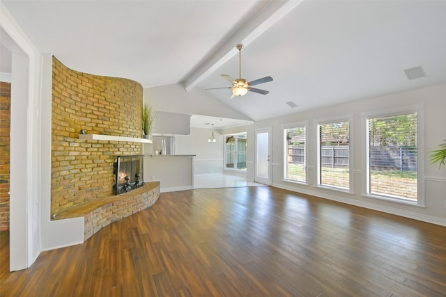 unfurnished living room with ceiling fan, a fireplace, dark hardwood / wood-style floors, and lofted ceiling with beams