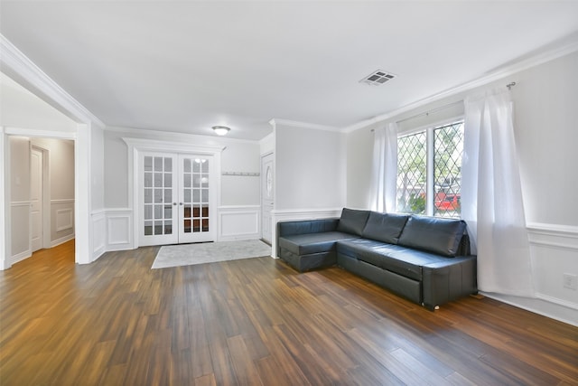 unfurnished living room with dark hardwood / wood-style flooring, ornamental molding, and french doors