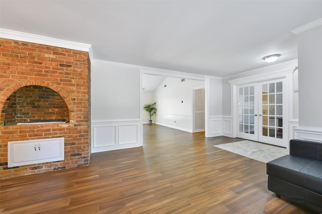 living room with crown molding, dark hardwood / wood-style flooring, and french doors