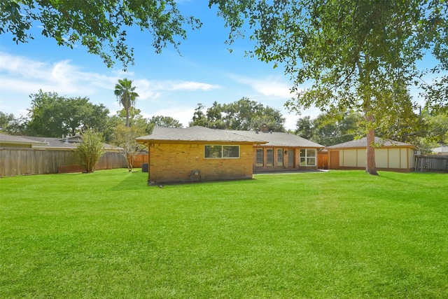 back of property featuring a lawn