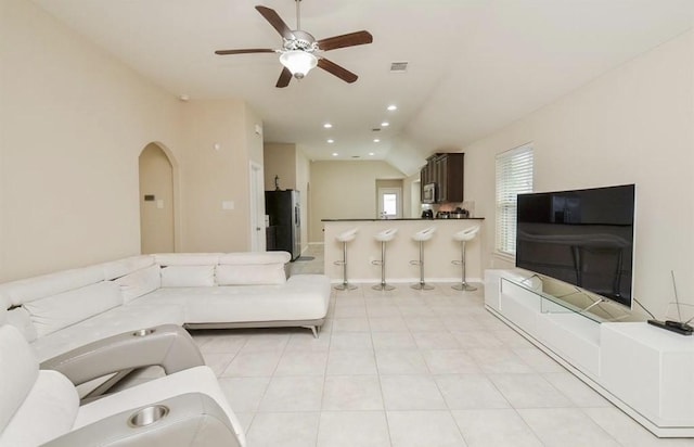 tiled living room with vaulted ceiling and ceiling fan