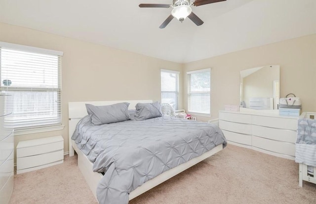 carpeted bedroom with ceiling fan and multiple windows