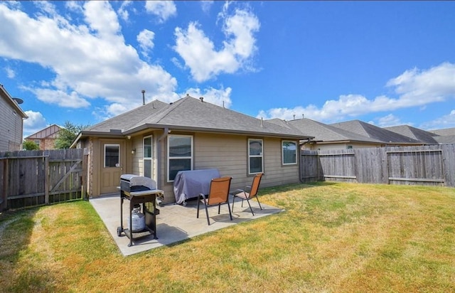 rear view of house with a yard and a patio area